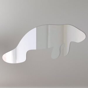 Decorative mirror shaped like a manatee with a sign.