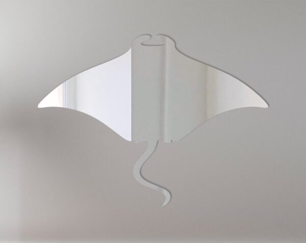 Manta ray-shaped mirror with etched details on blue background.