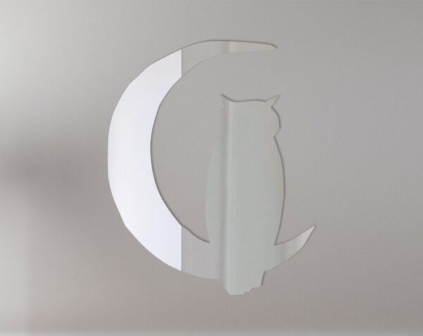 Owl silhouette on crescent moon-shaped mirror sign.