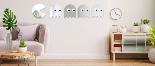 Set of 5 PACMAN-shaped decorative mirrors on wall.