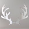 Mirror sign shaped like reindeer antlers with festive details.