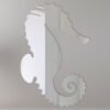 Decorative seahorse-shaped mirror with intricate details.