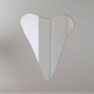 Decorative mirror shaped like a shark tooth with a sign.