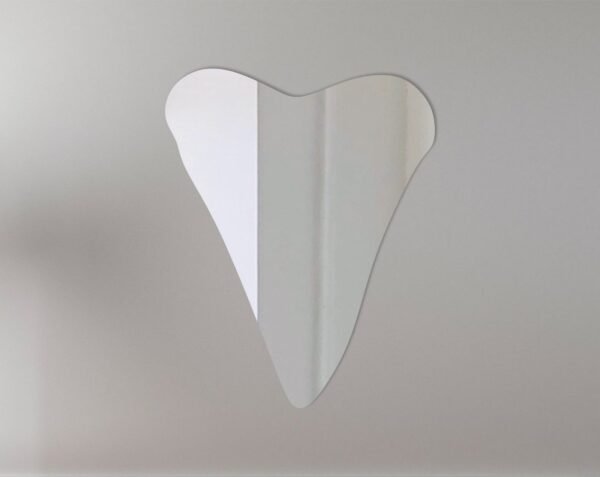 Decorative mirror shaped like a shark tooth with a sign.