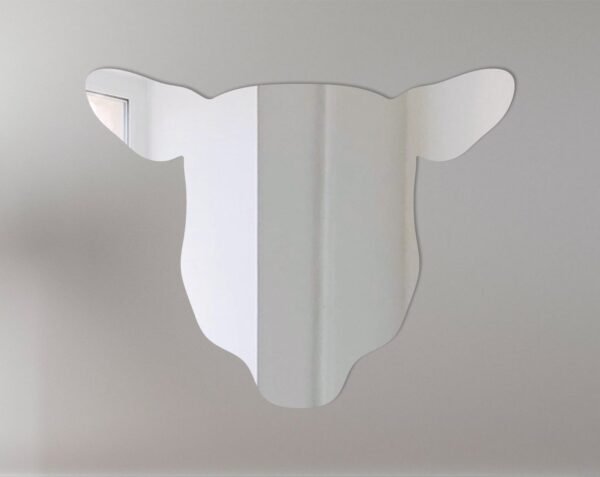 Sheep head-shaped mirror with reflective surface and hanging fixture.