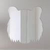 Tiger head design on circular mirror with neon sign.