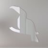 Toucan-shaped mirror with vibrant frame and hanging sign.