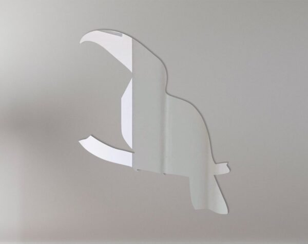 Toucan-shaped mirror with vibrant frame and hanging sign.