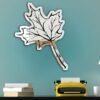 "Mirror featuring a decorative maple leaf design"