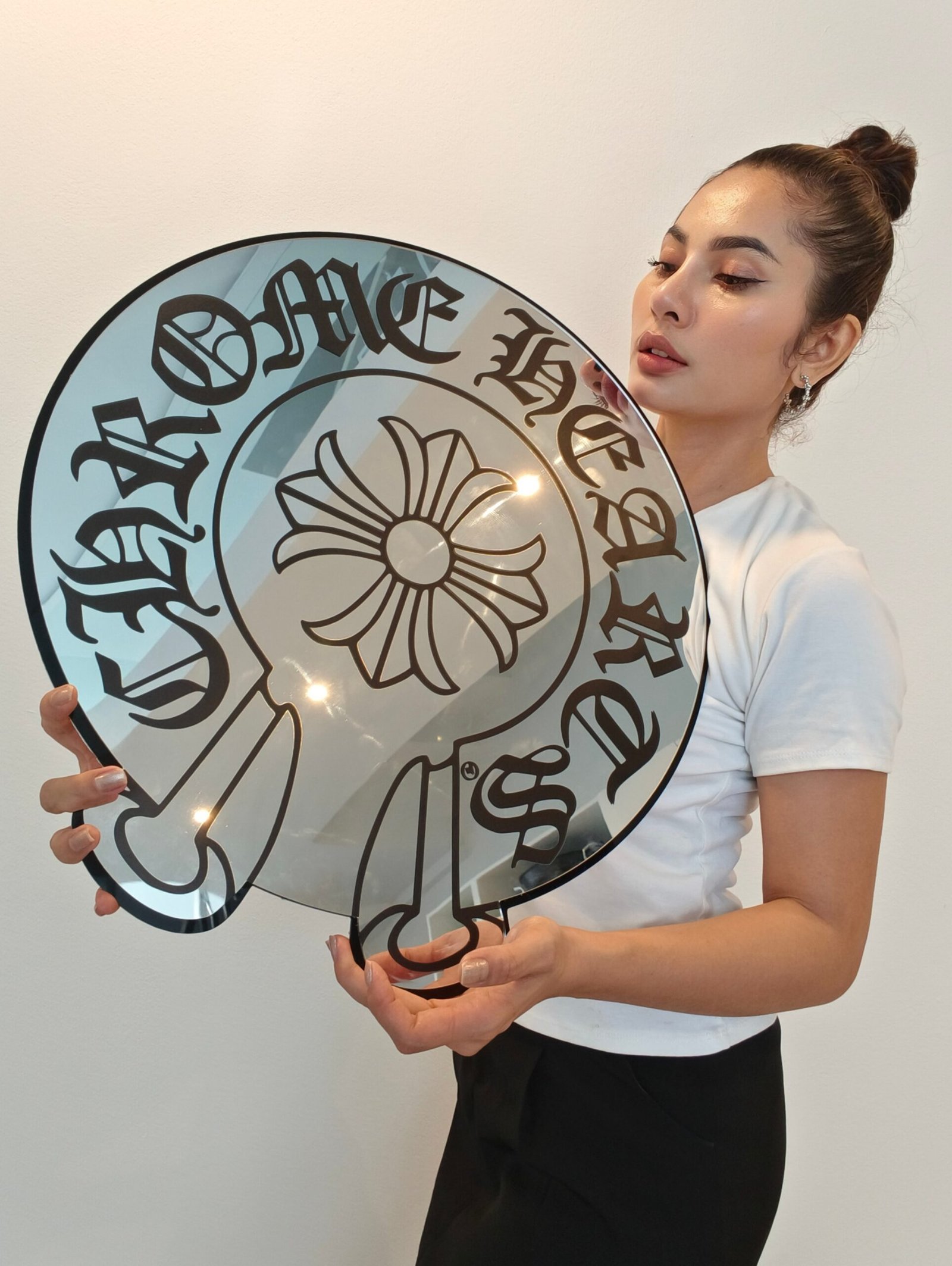 Custom mirror shaped like the Chrome Hearts logo, featuring intricate designs