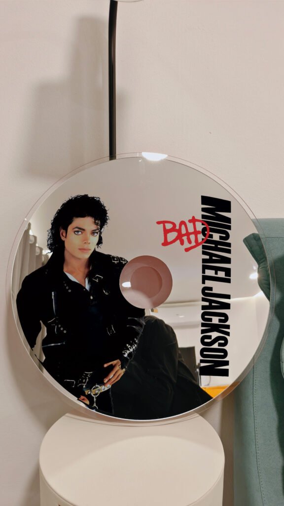 Shop our unique CD mirror inspired by Michael Jackson's iconic 'BAD' album. Perfect for fans and collectors, this decorative mirror combines functionality with a tribute to one of music's greatest legends. Available in various sizes, it's a must-have for any MJ enthusiast.