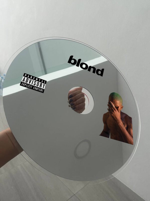 A vibrant round mirror with the 'Blond' logo and Frank Ocean artwork