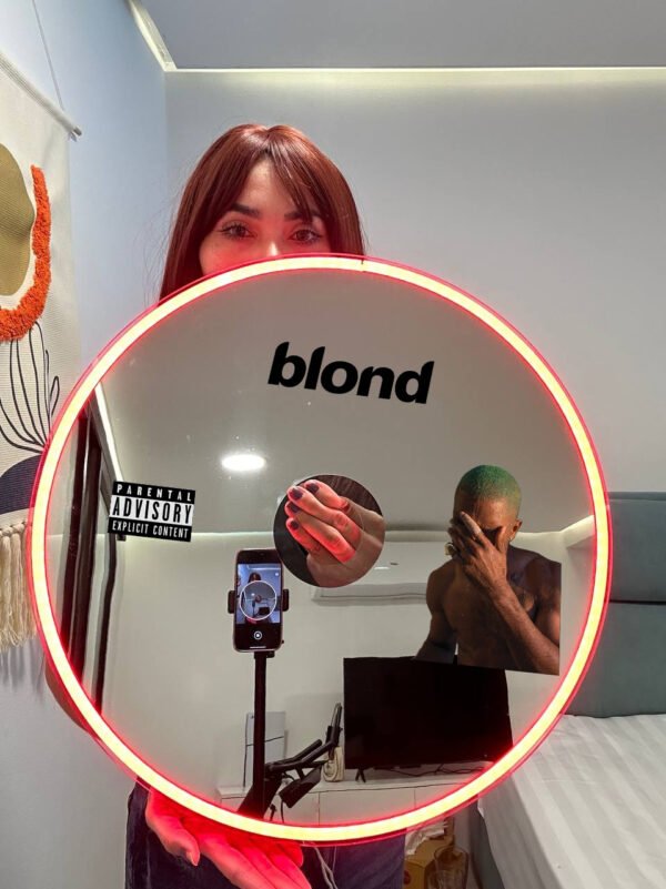 A round mirror featuring the 'Blond' logo and Frank Ocean artwork, surrounded by RGB neon lights in red.