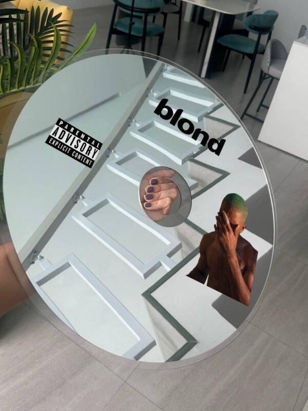 A stylish round mirror with 'Blond' branding and Frank Ocean imagery, perfect for music-inspired decor