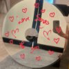 Handcrafted Love Songs CD mirror featuring red hearts and personalized text, ideal for romantic spaces