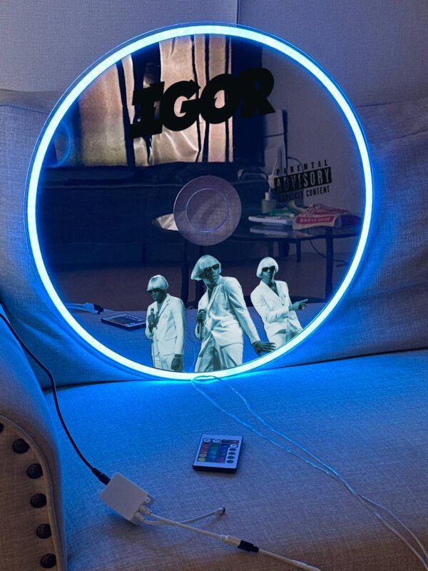 yler, The Creator IGOR CD Mirror with RGB neon lighting, glowing pink and blue.