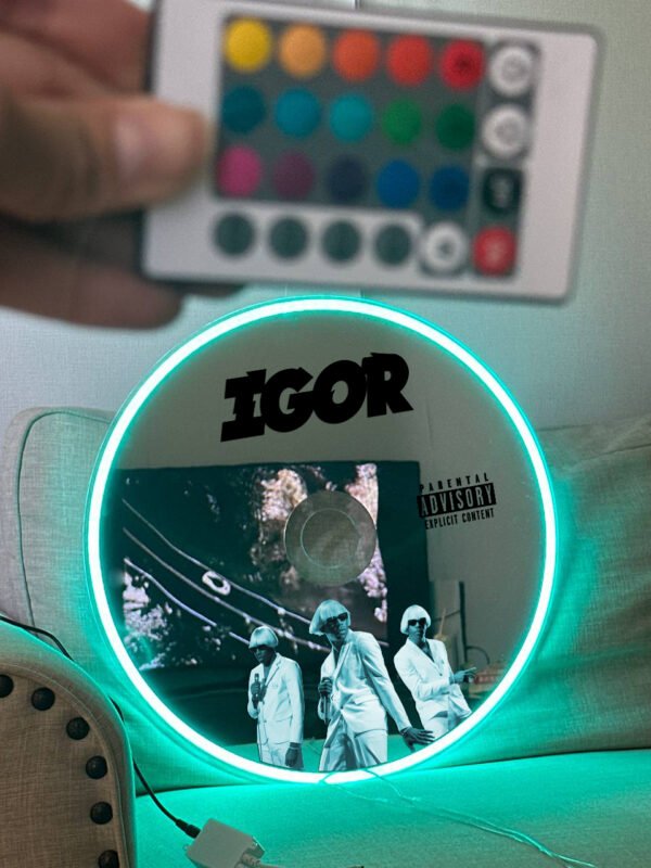 IGOR album-inspired CD mirror with RGB lighting, mounted on a wall.